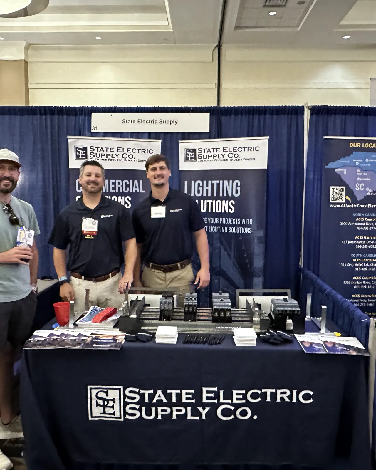 An exhibitor speaking with attendees at the NCAEC trade show